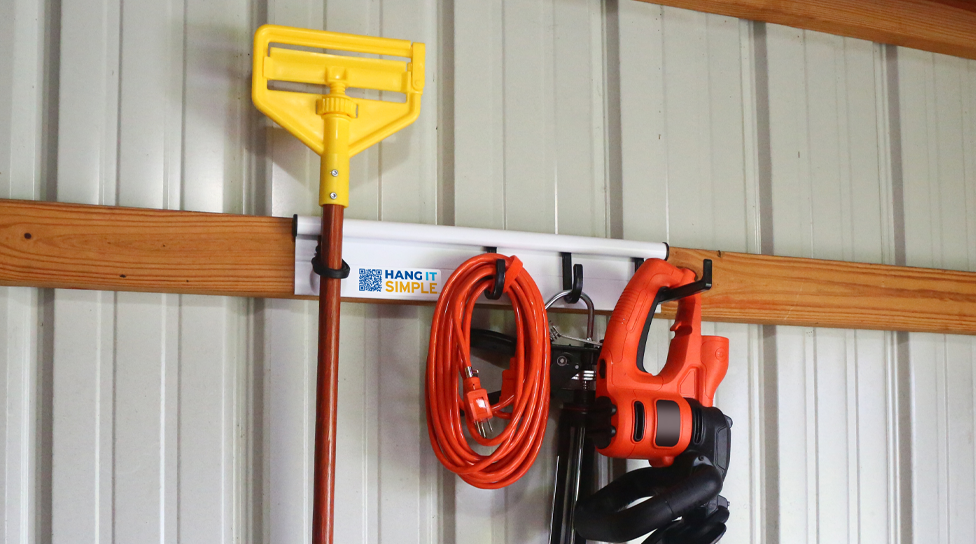 Wall mounted Hang It Simple 18" started kit with brooms, extension cords and other organized tools